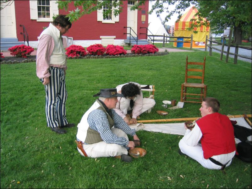 Geoff and Josh chowing,<br>Steven sewing, Myron supervising